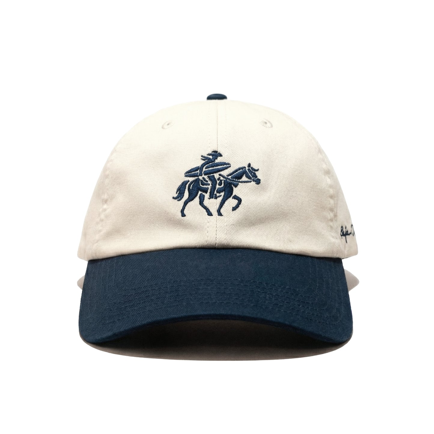 Beige and Navy cap with embroidered design of a surfing cowboy on a horse on a white background