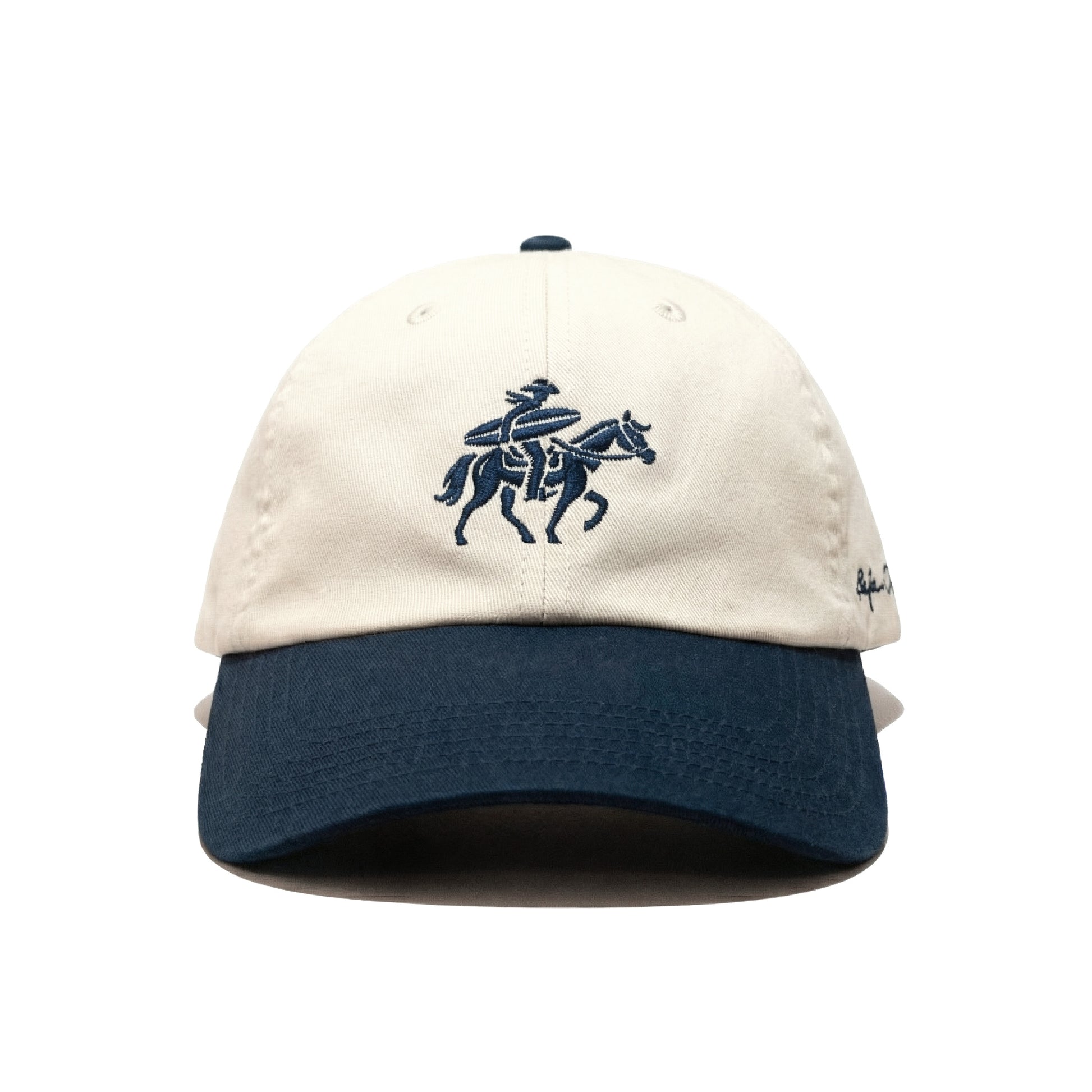 Beige and Navy cap with embroidered design of a surfing cowboy on a horse on a white background